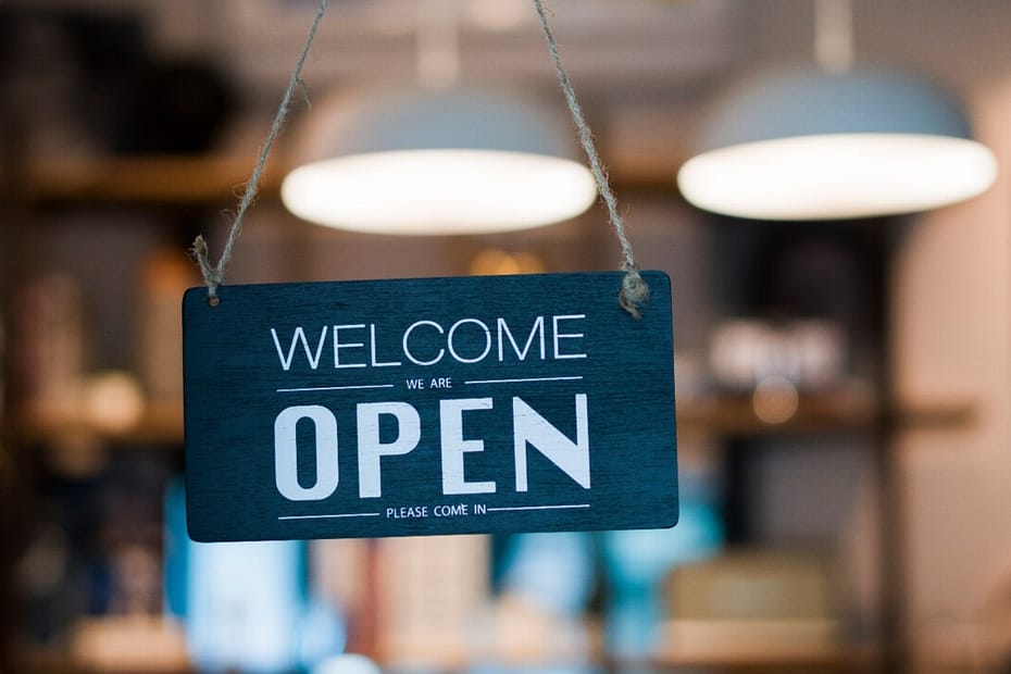Welcome we are open sign hanging in a shop or restaurant